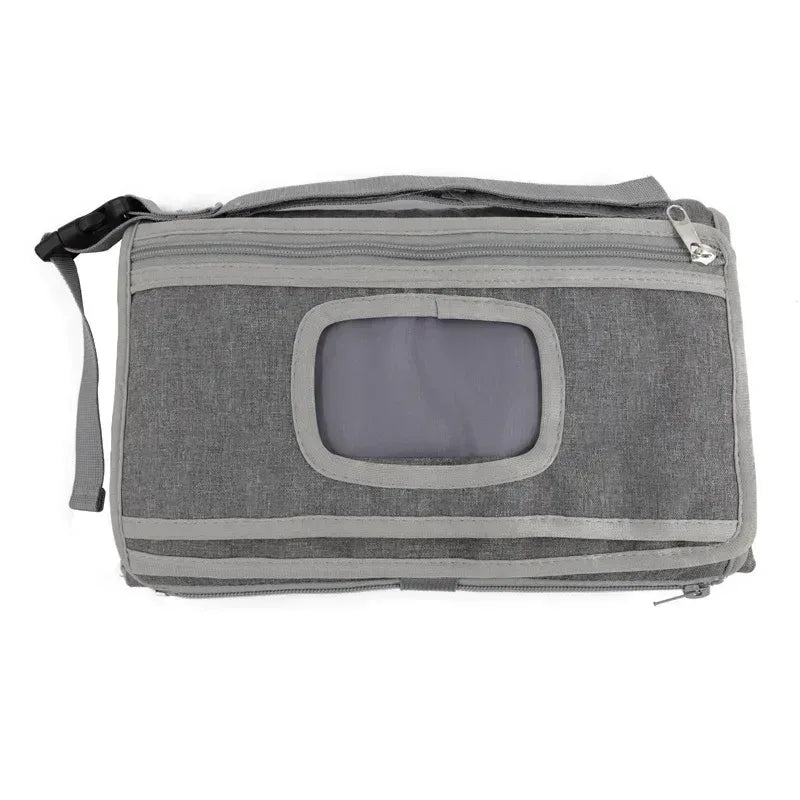 Fasciatoio portatile per neonati con tasche chiuso su sfondo bianco